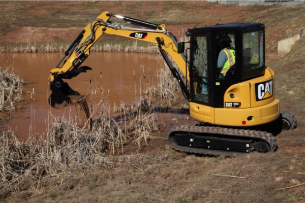 Mini excavator by swamp