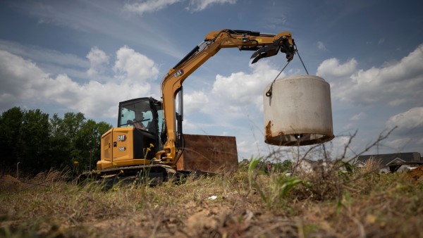 Mini Excavator lifting culvert