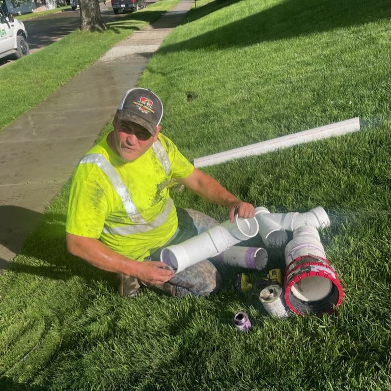 Plumber assembling white pipes